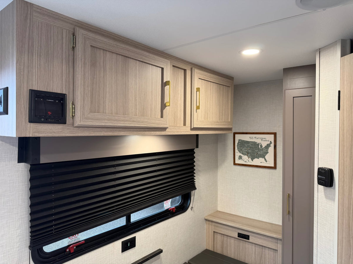  and a U.S. National Parks map.|Cozy RV rental interior features a compact kitchen with microwave — photo 16
