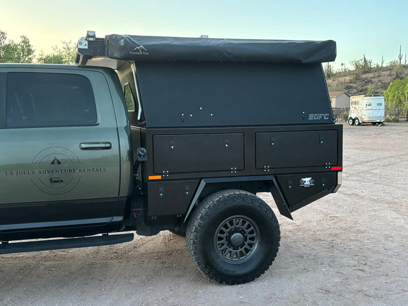  a modified green pickup truck with a black flatbed camper & rooftop tent — photo 2