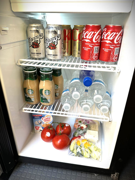 This rv rental mini-fridge is stocked with Barq's, Coke, Starbucks, water, Coffee-mate, fresh tomatoes, and pre-cut veggies.