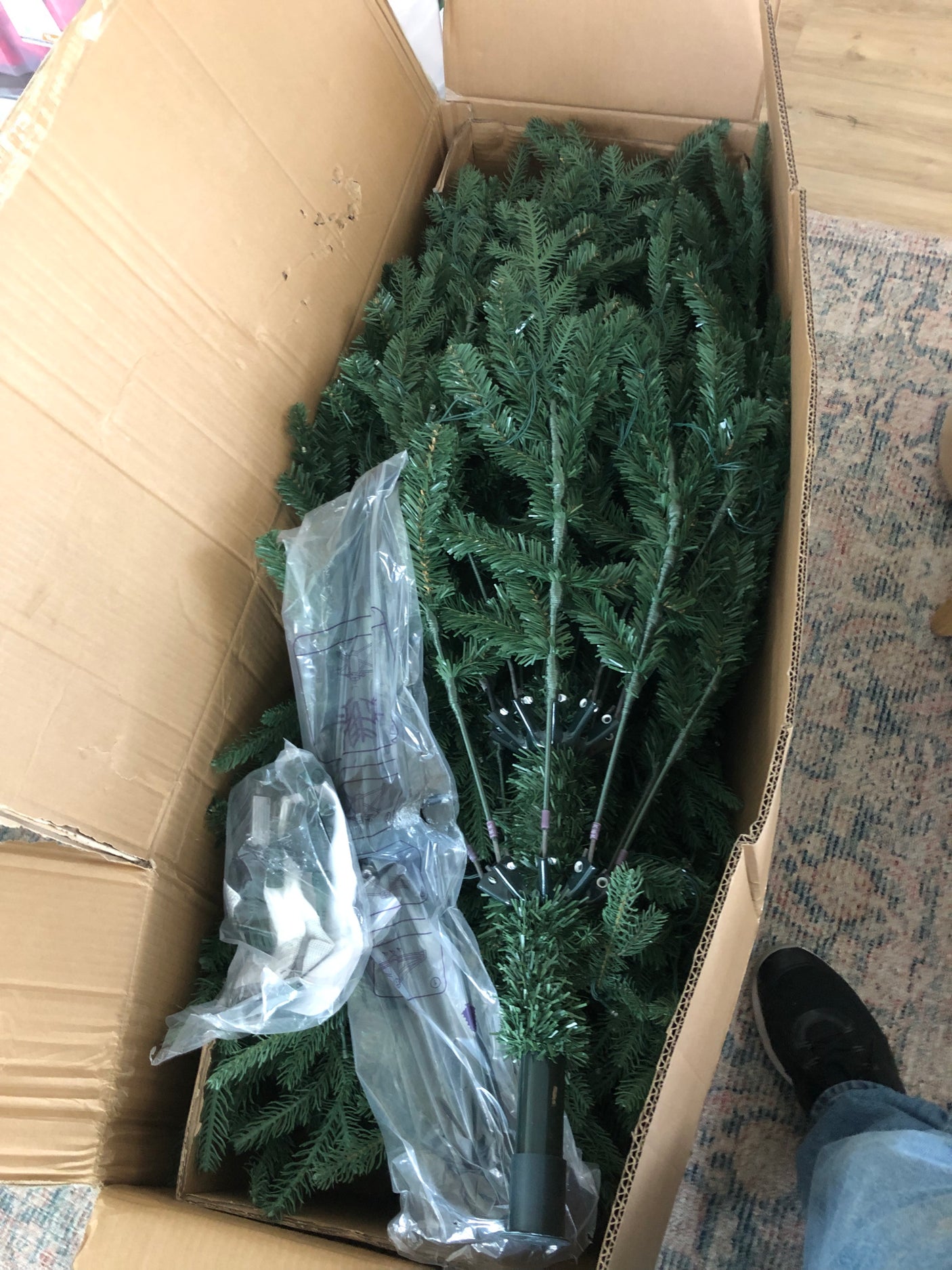 Boxed artificial Christmas tree parts, ready for assembly. Perfect holiday decor, maybe for an RV rental home-away-from-home!