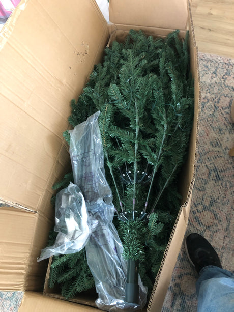 Boxed artificial Christmas tree parts, ready for assembly. Perfect holiday decor, maybe for an RV rental home-away-from-home!