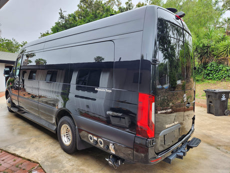 Sleek black Mercedes-Benz Sprinter luxury RV, branded "Ultimate Toys," ideal for your next rv rental adventure.