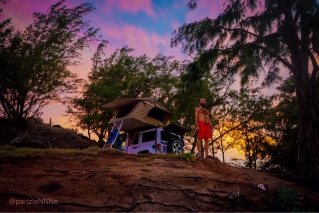 This RV rental features a roof top tent on a Jeep, perfect for sunset camping and outdoor exploration.