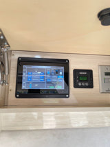 Detailed view of an RV rental's internal control panel, displaying essential Airstream system info and gauges.