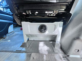 RV rental: Under-seat unit with a black vent, durable flooring, and a white charging cable for occupant comfort.