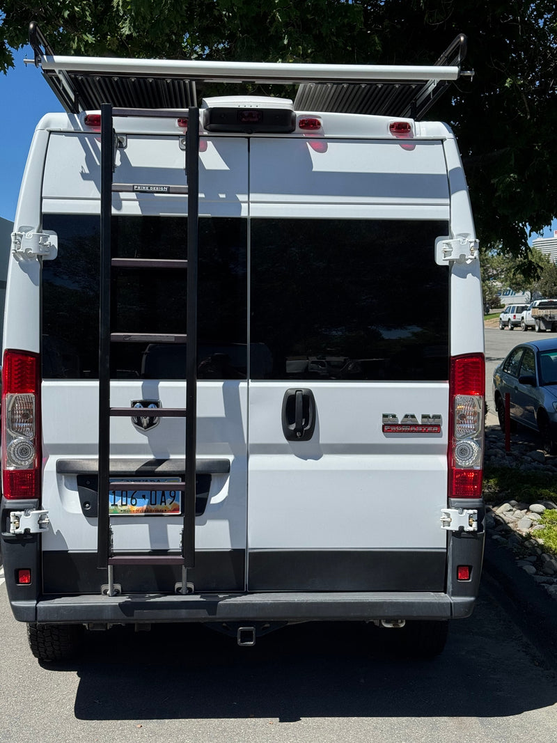  ideal for rv rental. Parked on asphalt beside landscaping.|Rear view of a white Ram ProMaster camper van — photo 2