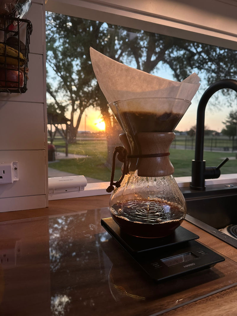 Enjoying a serene Chemex coffee brew in an RV rental kitchen, with beautiful sunset views through the window. — photo 6