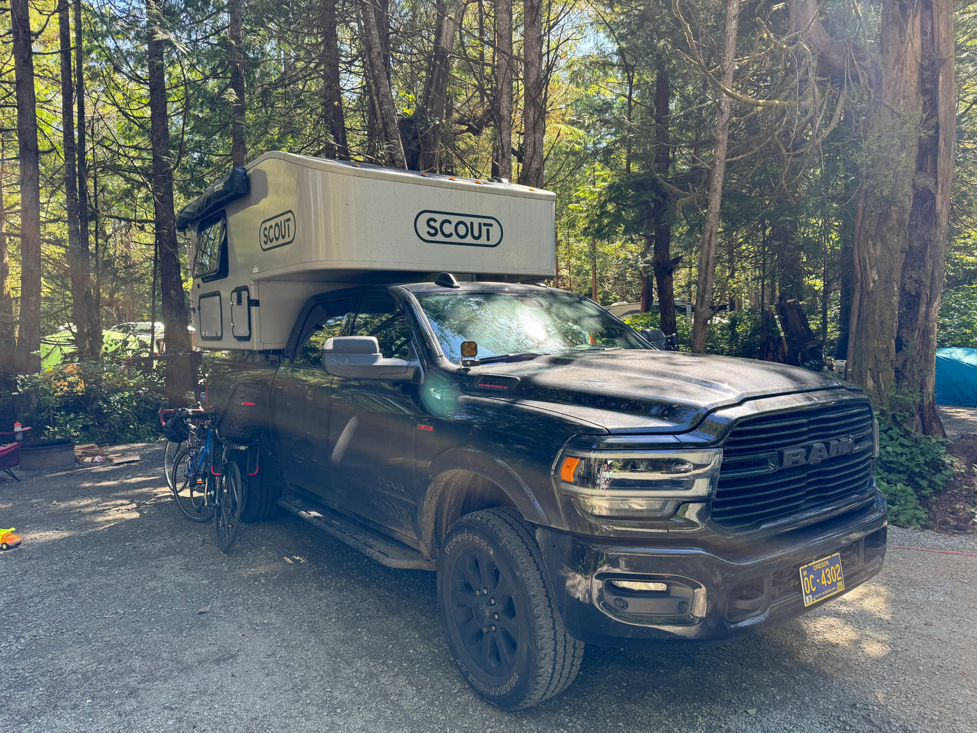 This Scout truck camper RV rental is parked in an Oregon forest campground, ready for outdoor adventures. — photo 3