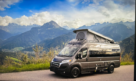 Pop-top camper van rv rental on a mountain road. Explore scenic landscapes & outdoor adventures.