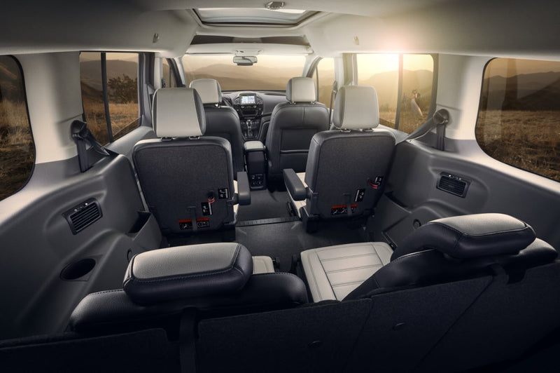  offering expansive cargo or potential sleeping space.|RV rental interior features comfortable black driver and passenger seats — photo 11