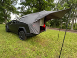  with a rear tent and awning in a grassy field.|Unique truck bed tent setup
