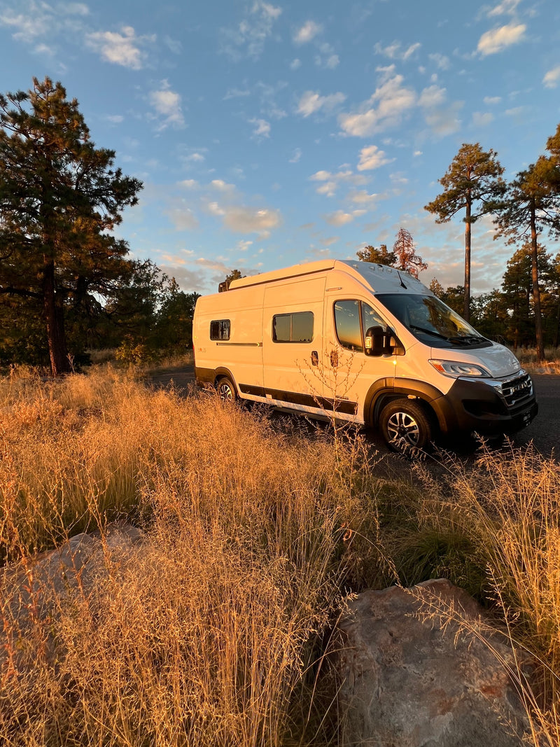  parked in sunny desert landscape.|White Solis camper van with pop-top roof open — photo 3