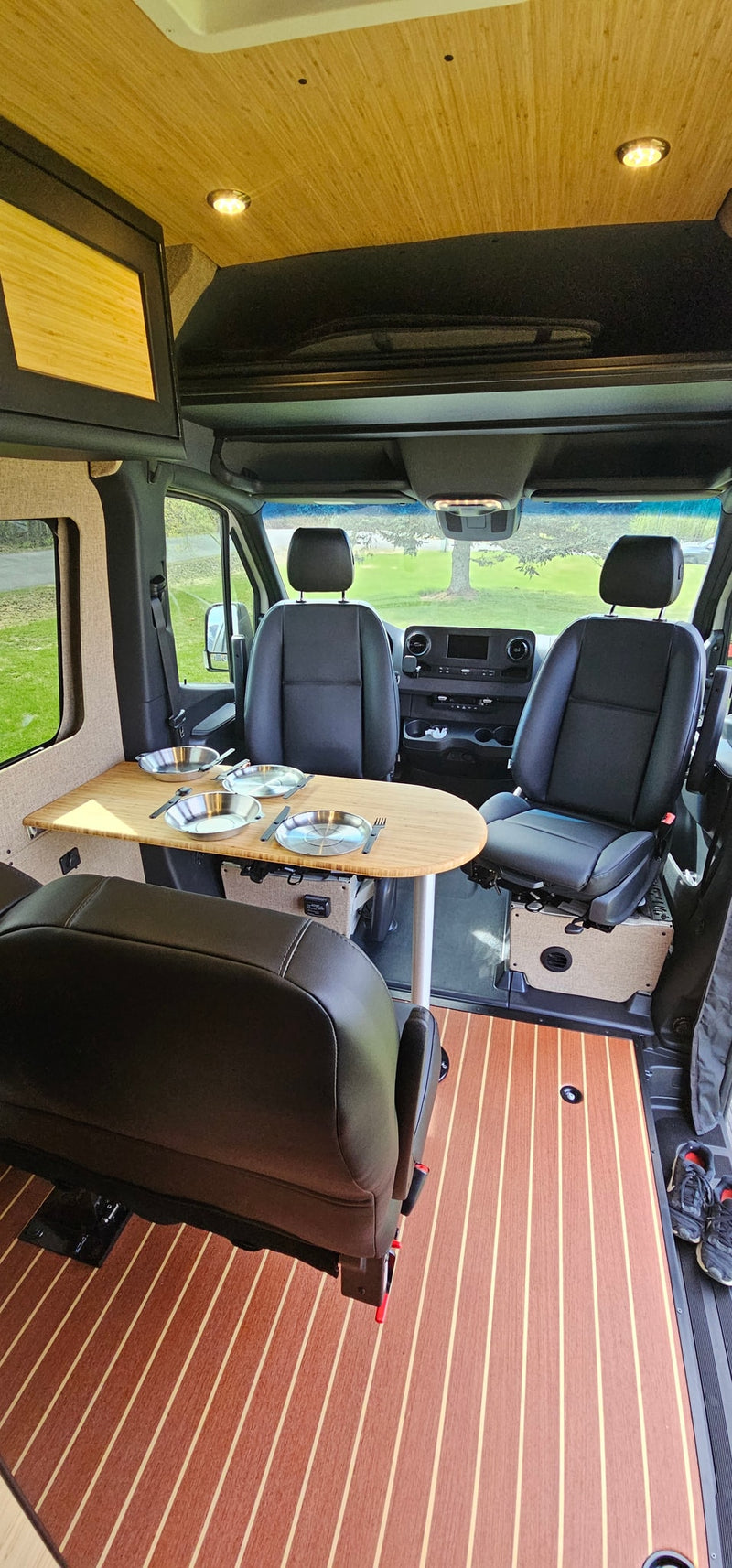  and table on grass against snowy mountains.|RV rental van set up with an awning — photo 8