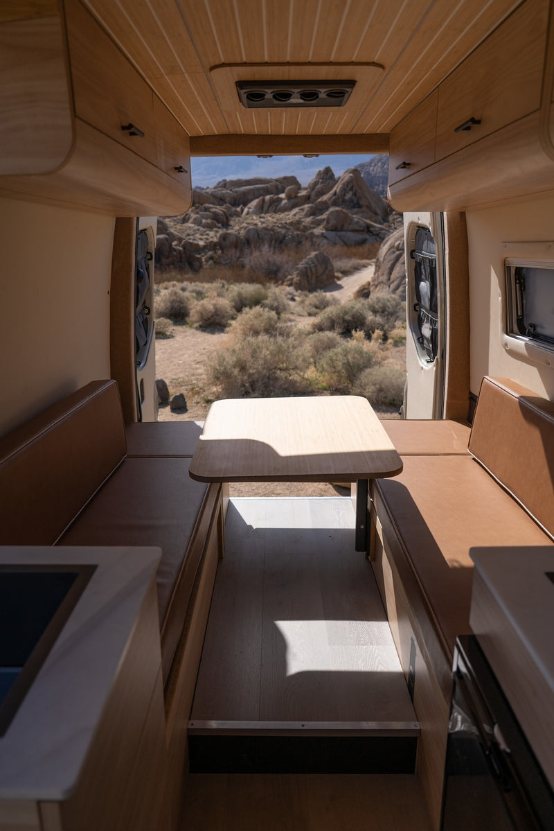 and open rear doors reveal a stunning desert landscape. A kitchenette is visible foreground.|Modern compact kitchen in an RV rental — photo 5