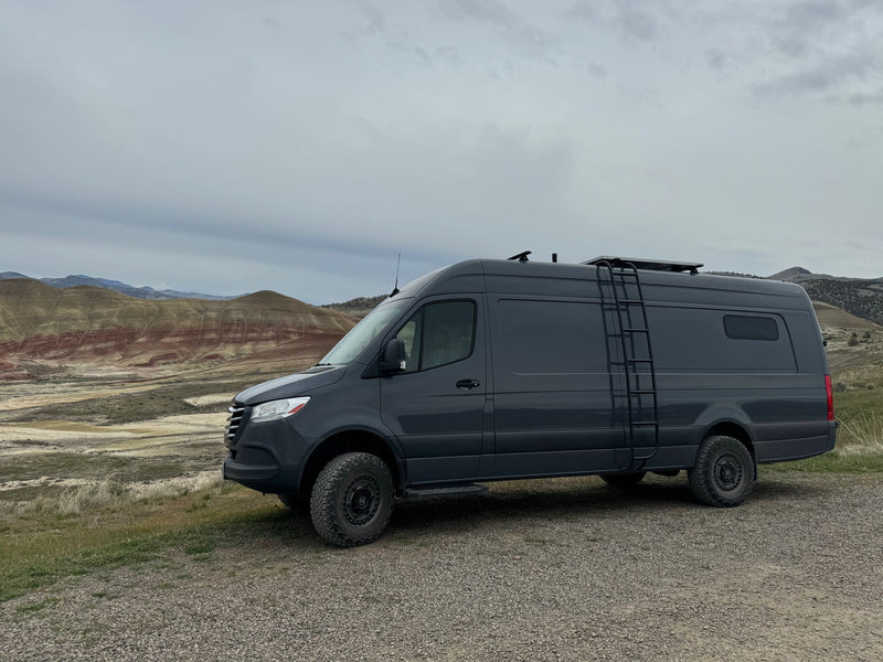 and comfy side seating.|Cozy RV rental interior showcasing a compact kitchen — photo 8