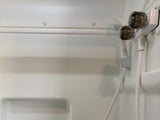 An RV rental's white, molded shower stall interior featuring a two-knob faucet and attached handheld shower head.