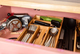 RV rental kitchen drawer: neatly organized utensils, French press, and measuring cups for your travels.