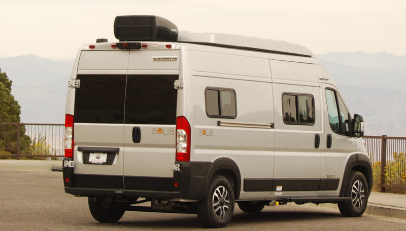  near a "Scenic Overlook" sign.|Inside a compact rv rental: cozy bed with graphic bedding — photo 10
