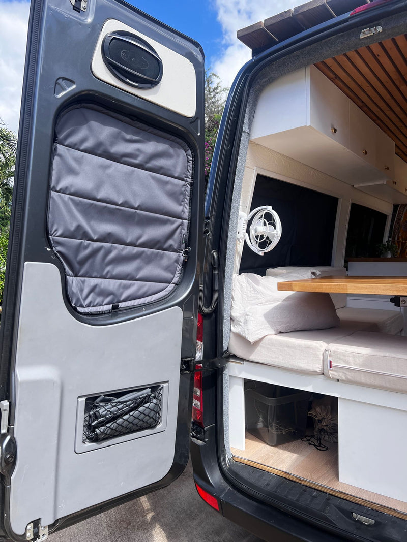  and compact kitchen area with natural light.|RV rental comfort: A cozy van interior with a bed — photo 3