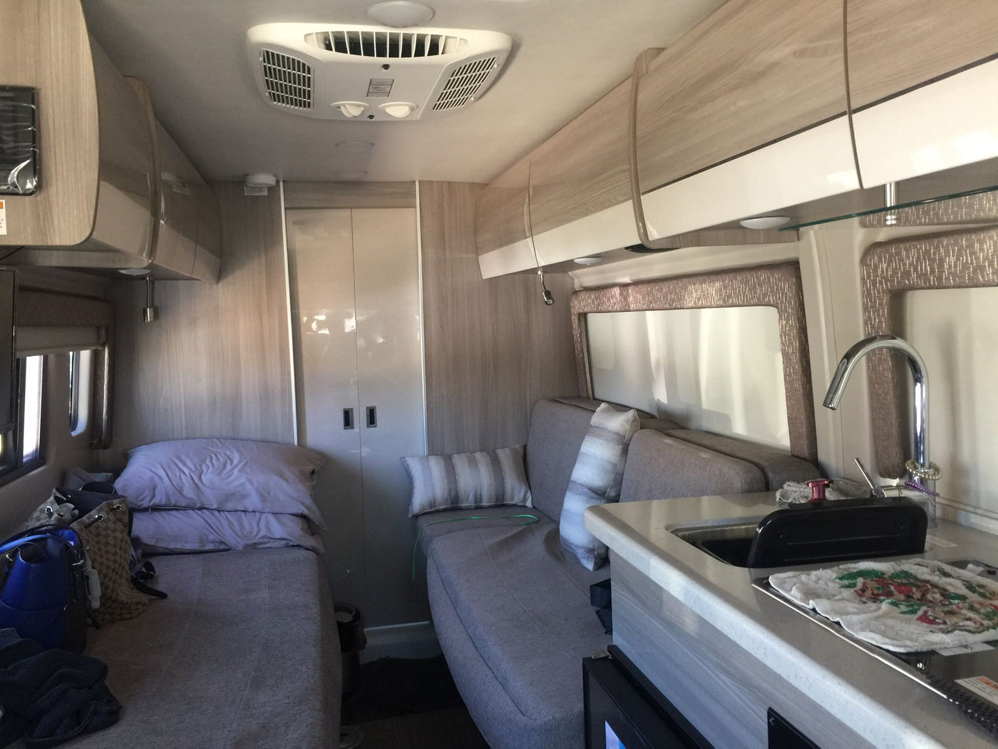  & outside view through windshield.|Inside an rv rental: A compact kitchen area featuring a High Pointe microwave — photo 5