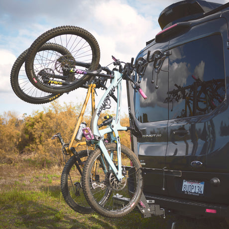 RV rental van: A Ford Transit with two mountain bikes on a rear rack, ready for outdoor adventure.
