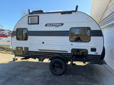Sunray Sport travel trailer RV rental, a light-grey camper with off-road tires & roof rack, ready for your next adventure.