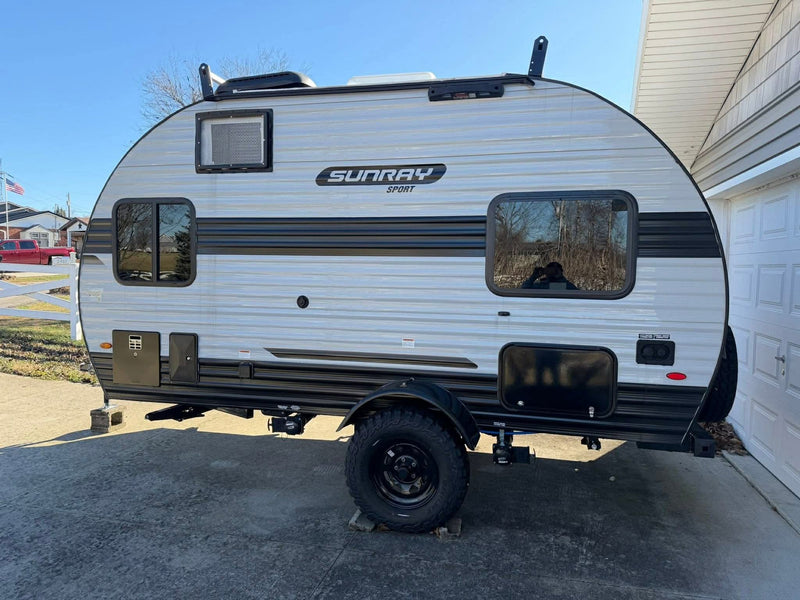 Sunray Sport travel trailer RV rental, a light-grey camper with off-road tires & roof rack, ready for your next adventure. — photo 4