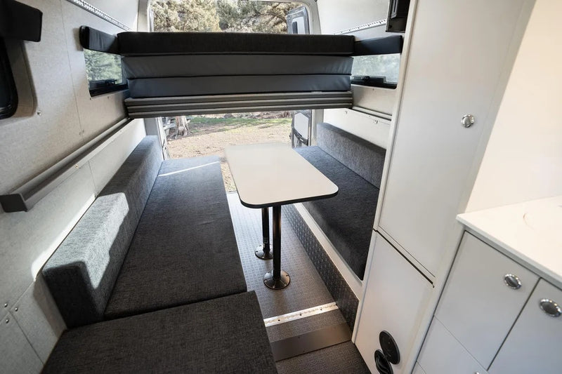  and upper cabinets. Ready for your next road trip.|RV rental campervan interior: dining area with benches — photo 6