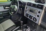 Toyota FJ Cruiser car interior: steering wheel, dashboard, and controls. Ideal for an adventurous RV rental journey.