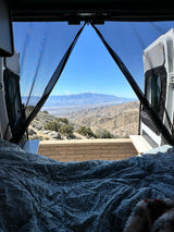 Scenic RV rental: wake up to breathtaking snow-capped mountain and desert views from your cozy van bed. Adventure awaits!