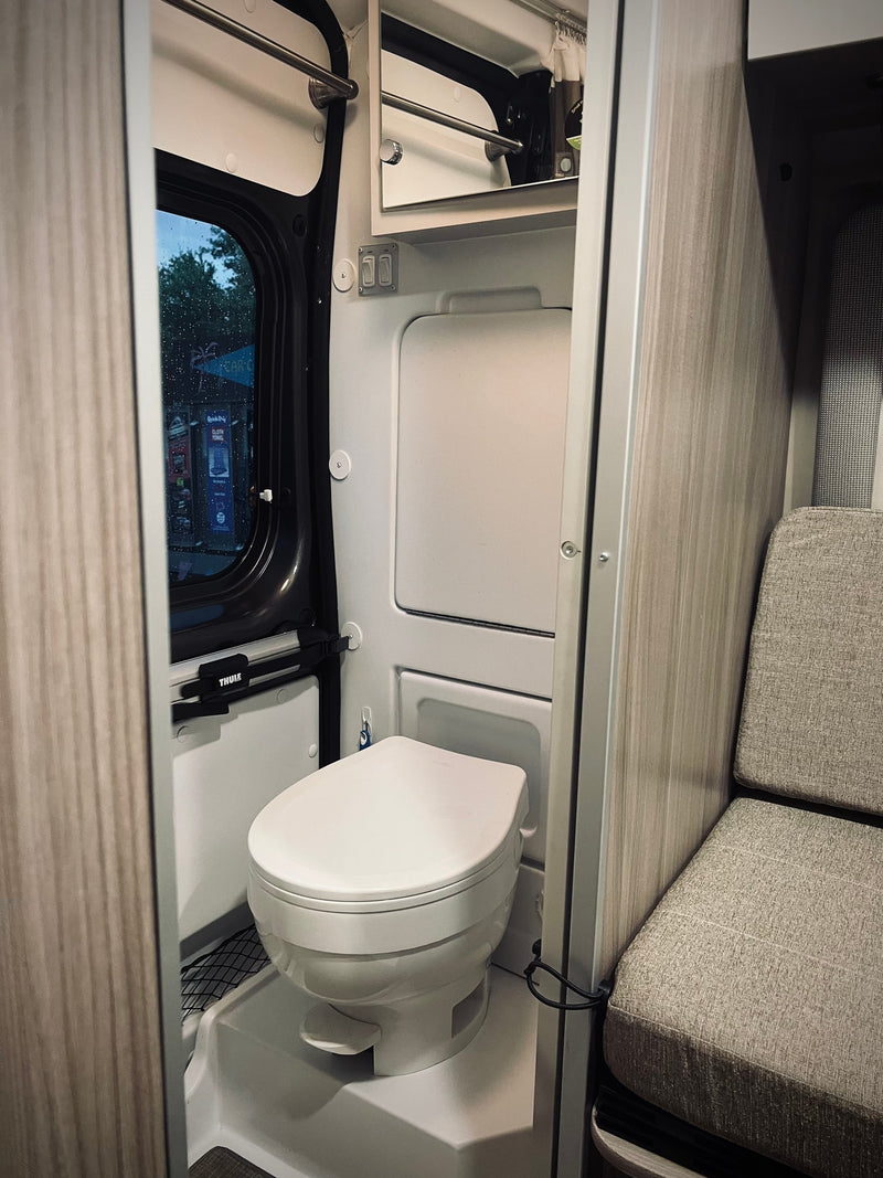  a cozy seat & TV provide comfort as you watch the peaceful waters.|Open mini-fridge with empty shelves & drawers — photo 16