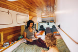 Woman and child relax in a cozy RV rental.