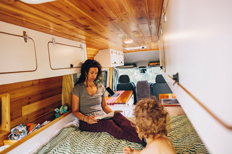 Woman and child relax in a cozy RV rental.