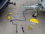 RV rental essentials: Trailer hitch components, safety chains, electrical adapters, jack, and security accessories.