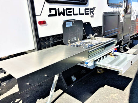 This RV rental features a convenient pull-out outdoor kitchen with a stove, sink, and prep space, perfect for camping adventures.