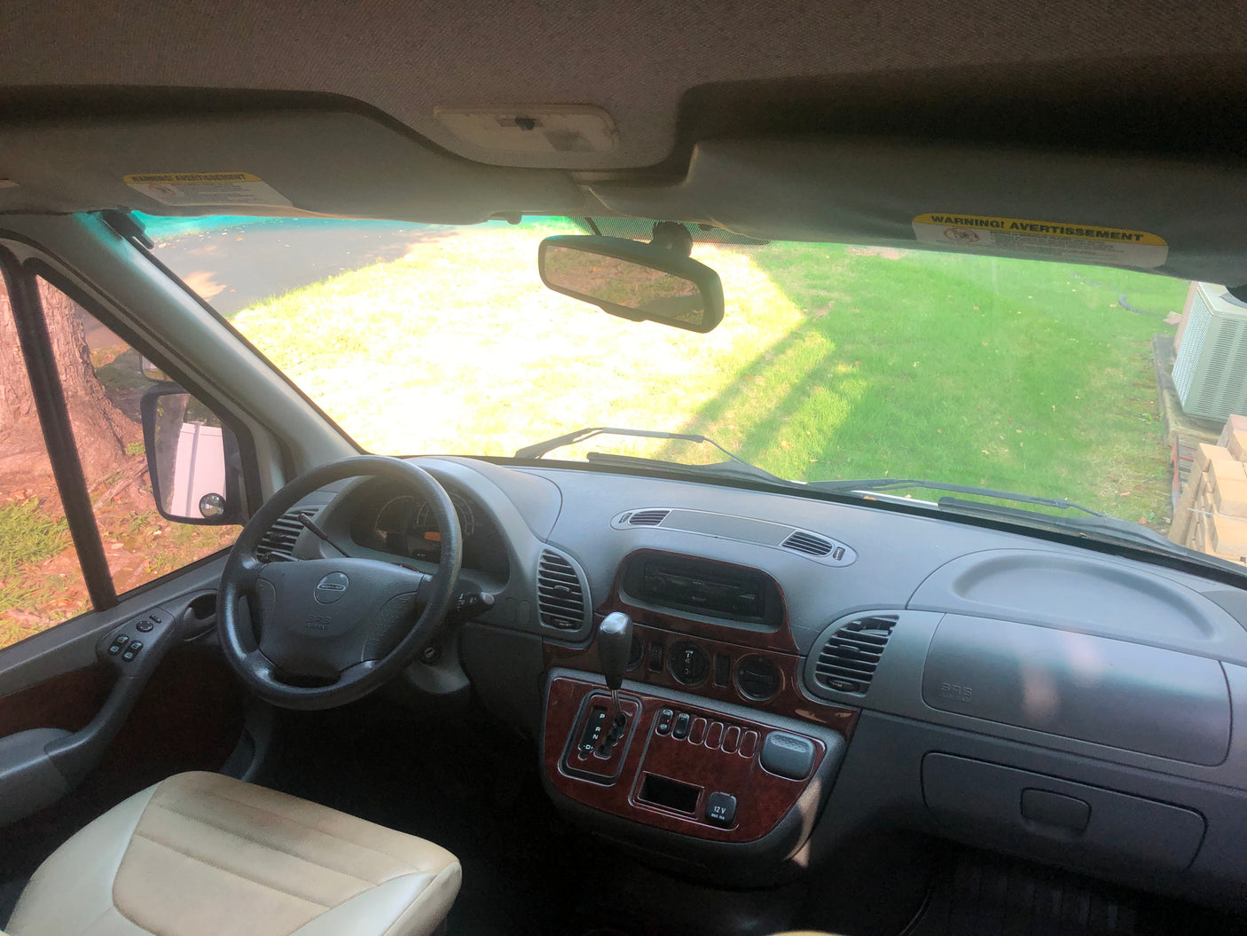 Inside an RV rental van: Driver's view showing the dashboard, steering wheel, and the road ahead through the windshield.