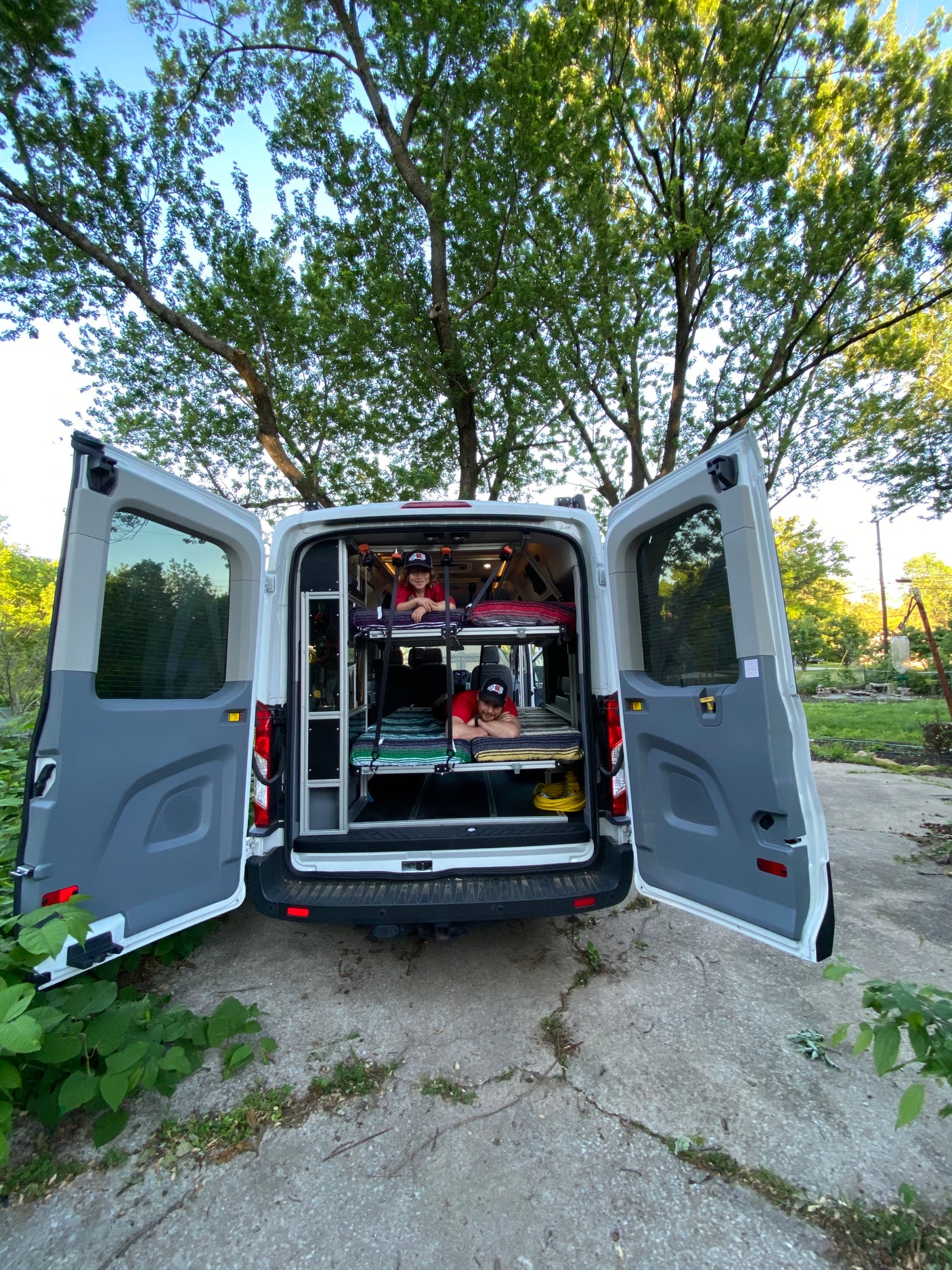 This custom camper van offers tiered bunks for travel. Ideal for your next RV rental adventure.