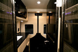 Luxury rv rental van interior featuring a modern kitchen with a microwave and sink, perfect for comfortable travel.