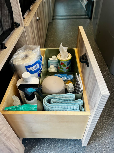 An organized RV rental drawer, stocked with cleaning supplies and toiletries, ensures a tidy journey.