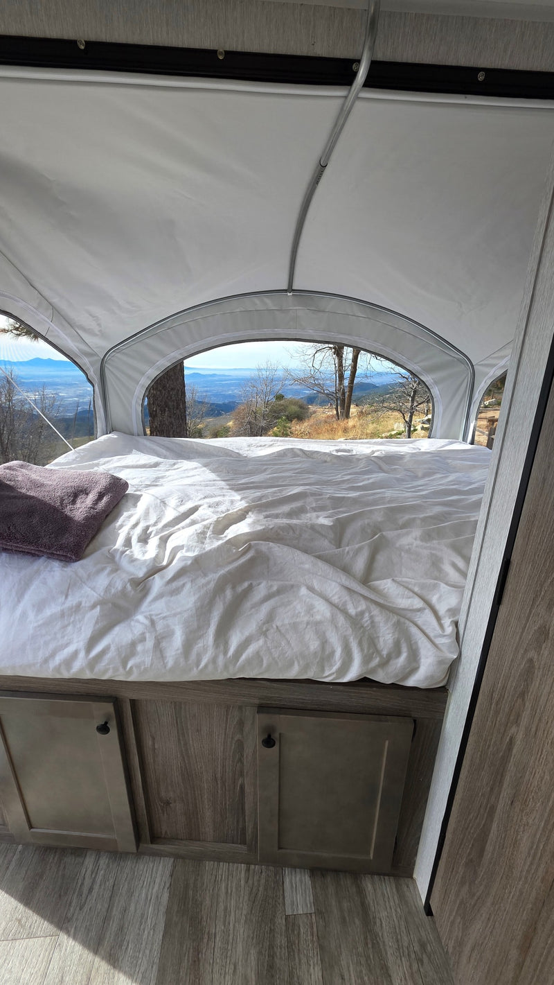 Enjoy breathtaking mountain views from a comfortable pop-up camper RV rental bed. Ideal for scenic travel! — photo 16