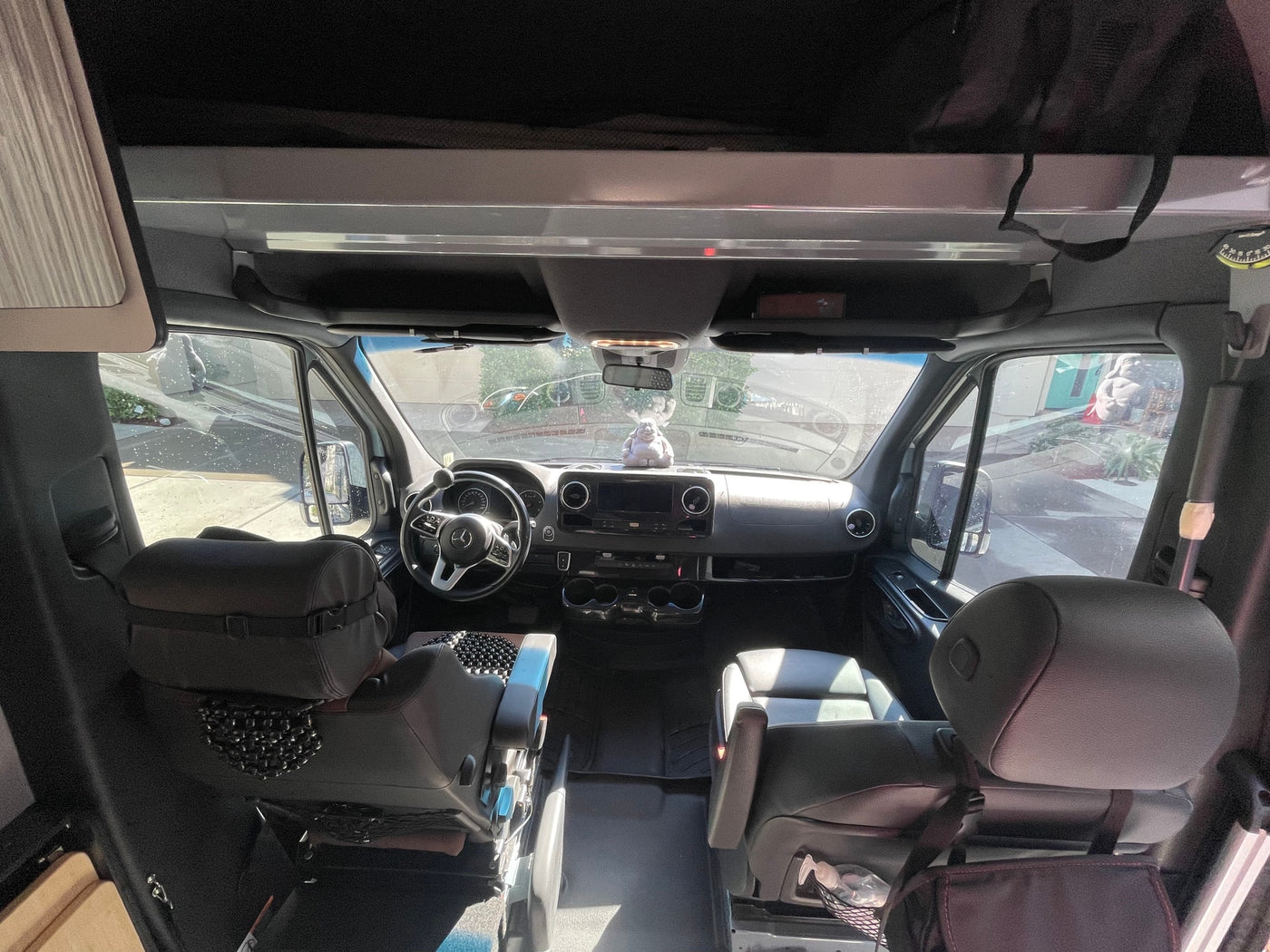 Inside an RV rental van, featuring the Mercedes-Benz Sprinter cockpit with dashboard, seats, and accessibility controls. — photo 7