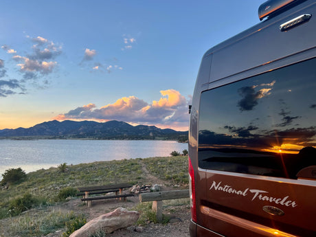 RV rental van offers stunning lakefront sunset views at a scenic campsite for your nature travel adventure.