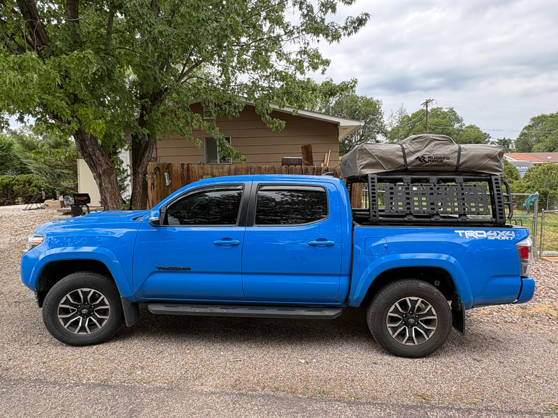 a great RV rental option for adventure.|A blue Toyota Tacoma pickup truck with a rooftop tent — photo 2