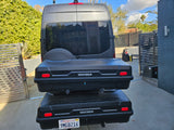 Rear of a dark gray rv rental van with two stacked Yakima cargo boxes, ideal for travel storage and adventures.
