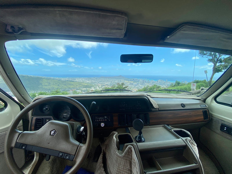 Dodge van RV rental view: Honolulu skyline, Hawaii. Dashboard & steering wheel inside. Perfect road trip. — photo 7