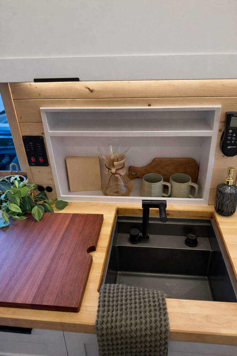  and overhead lighting create a cozy dining space.|Cozy camper van interior with kitchen — photo 5