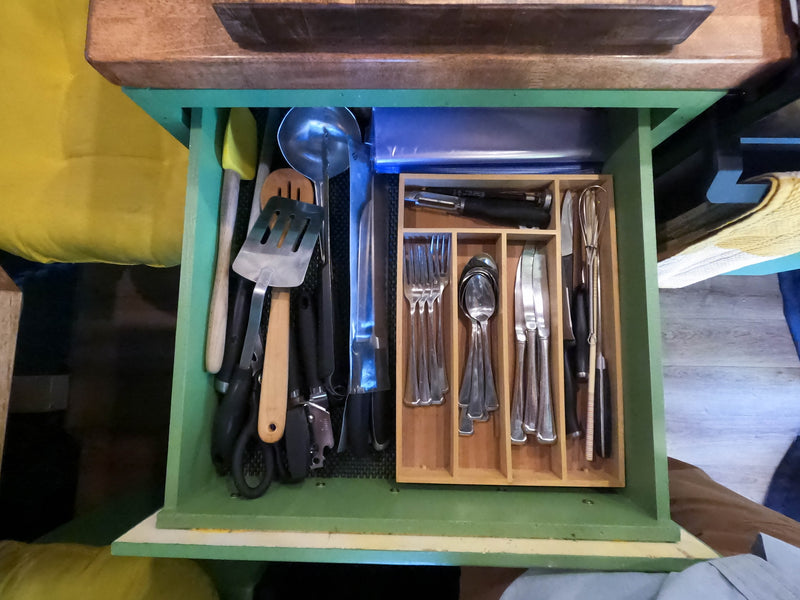 Organized kitchen drawer in an RV rental, filled with cooking utensils like spatulas, ladles, and neatly arranged silverware. — photo 13