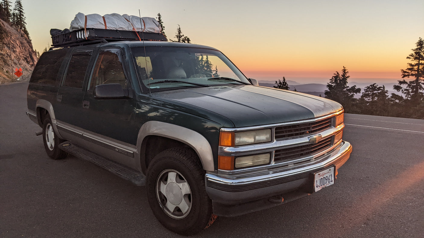 Scenic mountain sunset from a well-equipped SUV, an alternative to an RV rental for your next adventure.