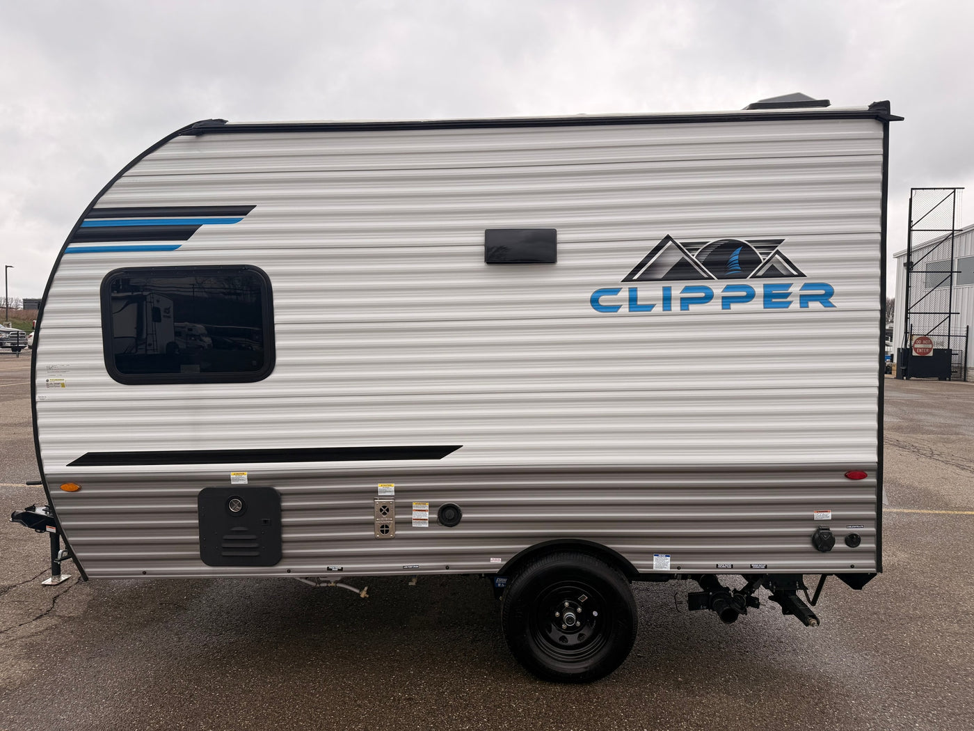 Compact Clipper travel trailer shown side view on asphalt, ideal for your next rv rental adventure.