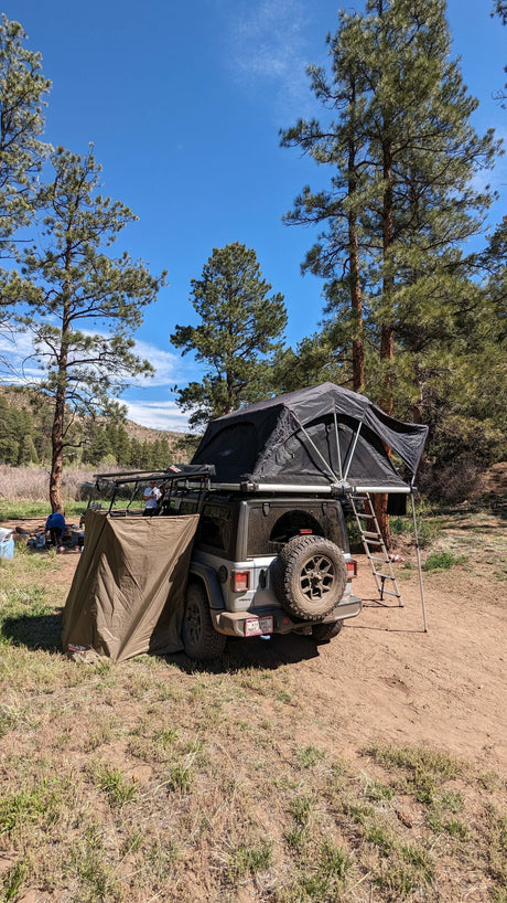 Rooftop tent camping with a Jeep and annex; a nimble RV rental alternative for outdoor adventure.